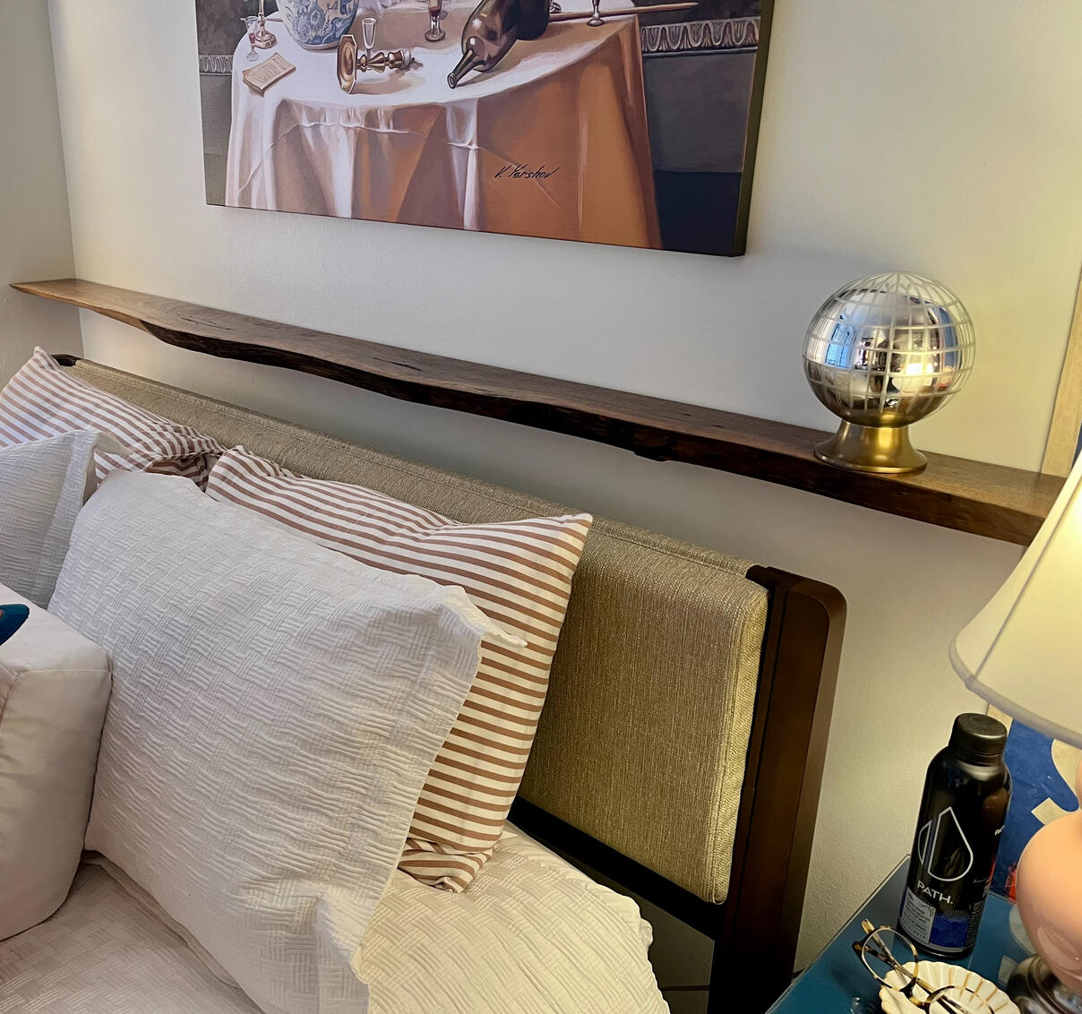 Walnut shelf above a bed